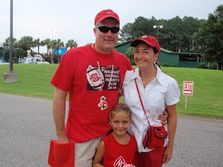 daugher and parents wearing red and white